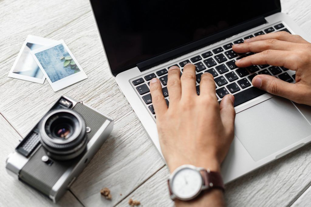 Travel Blogger With Laptop and Camera